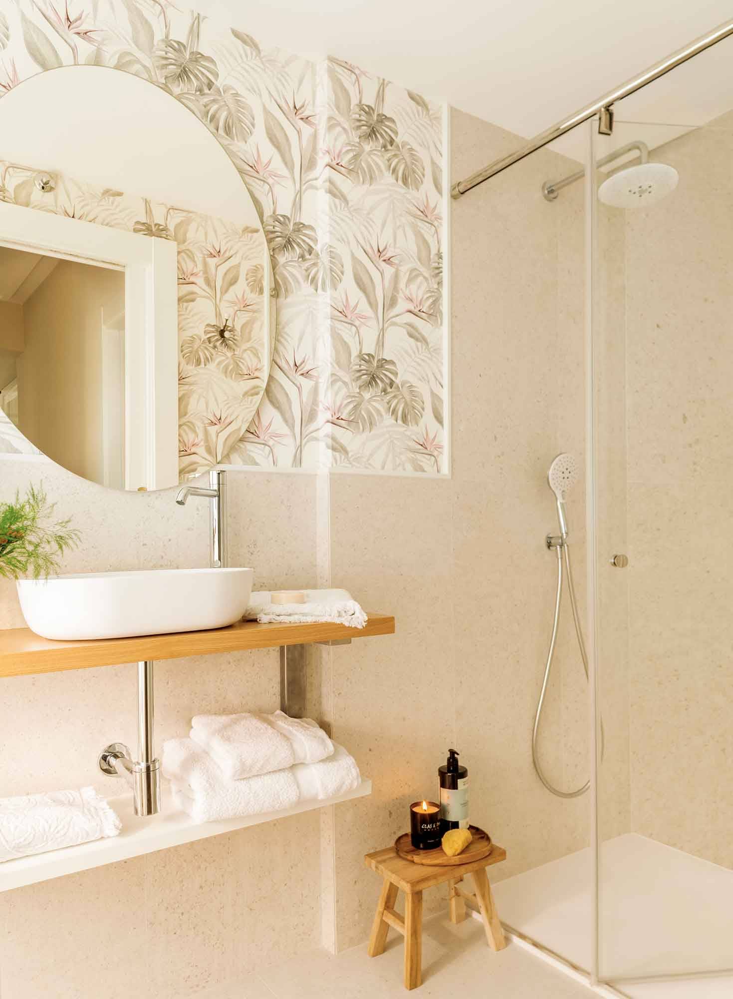 Baño pequeño con papel pintado y balda a modo de mueble bajolavabo. 